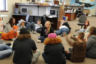 students seated on the floor in a circle for advisory